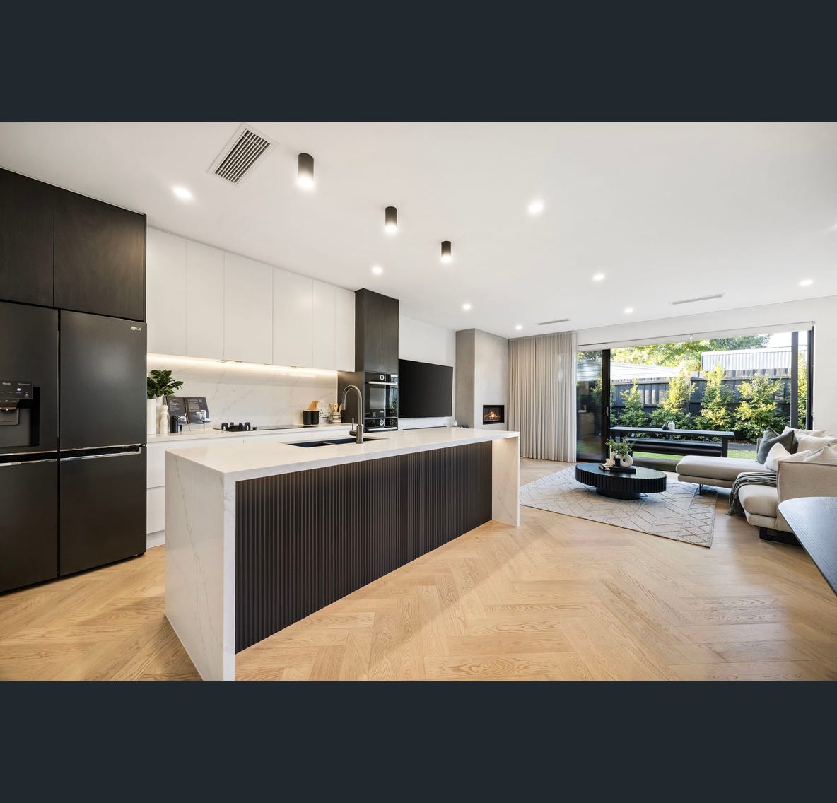 Kitchen perspective — stone benchtops & garden view